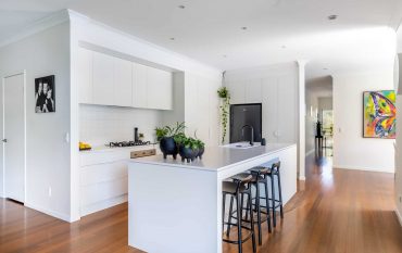 Modern white kitchen renovation with island