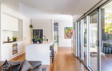 Modern white kitchen renovation with island