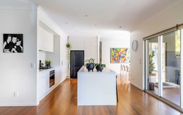 Modern white kitchen renovation with island